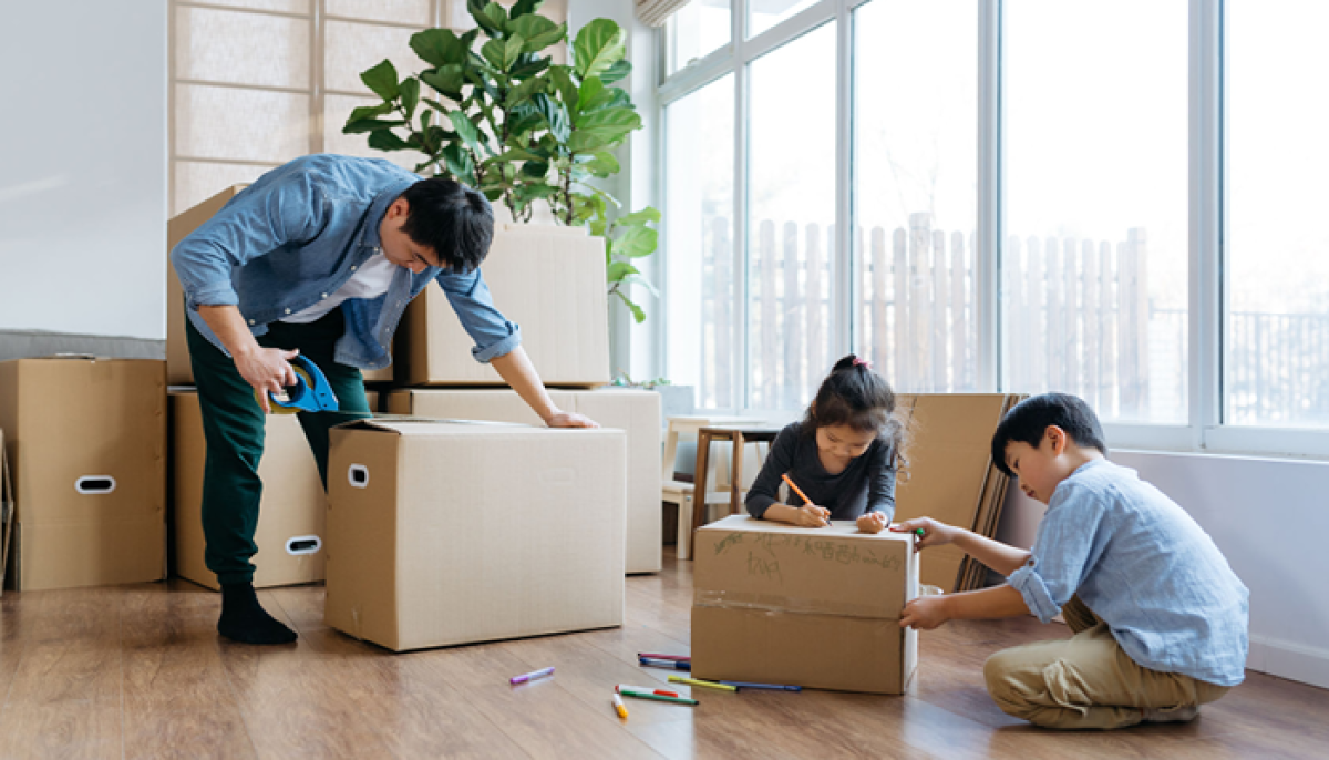 Family packing boxes to move